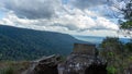 Picture of rocks located on the edge of a cliff. Looking down, I saw trees growing densely. Royalty Free Stock Photo