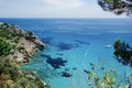 a picture of a rocky cliff with a blue water and some rocks Royalty Free Stock Photo