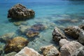 a picture of a rocky cliff with a blue water and some rocks Royalty Free Stock Photo