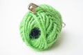 Picture of safety pin and green yarn. Royalty Free Stock Photo