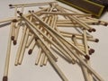 Picture of scattered match sticks and matchbox in background Royalty Free Stock Photo