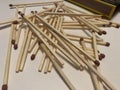 Picture of scattered match sticks and matchbox in background Royalty Free Stock Photo