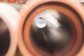 Selective blur on a PVC water pipe, with only the end of the tube being focused, taken in a water supply renovation construction