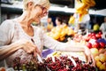 Picture of mature woman at marketplace buying vegetables Royalty Free Stock Photo