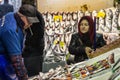 Old woman wearing the islamic scarf buying fish in the fish market of Kadikoy, on the Asian side.