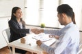 Asian female salesman sit in a modern office room and talk to customers and be satisfied with success. Royalty Free Stock Photo