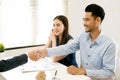 Asian female salesman sit in a modern office room and talk to customers and be satisfied with success. Royalty Free Stock Photo