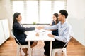 Asian female salesman sit in a modern office room and talk to customers and be satisfied with success. Royalty Free Stock Photo