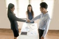 Asian female salesman sit in a modern office room and talk to customers and be satisfied with success. Royalty Free Stock Photo