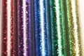 Picture of set five colors of glitters in glass jars - red, purple, blue, green, gold (yellow)