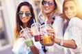 Happy girl friends hanging out in the city in summer Royalty Free Stock Photo