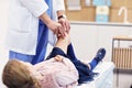 Little girl in clinic having a checkup with orthopaedist Royalty Free Stock Photo