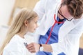 Little girl in clinic having a checkup with pediatrician Royalty Free Stock Photo