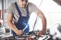 Picture showing muscular car service worker repairing vehicle Royalty Free Stock Photo