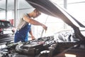 Picture showing muscular car service worker repairing vehicle Royalty Free Stock Photo