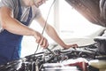 Picture showing muscular car service worker repairing vehicle Royalty Free Stock Photo