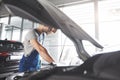 Picture showing muscular car service worker repairing vehicle Royalty Free Stock Photo