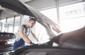 Picture showing muscular car service worker repairing vehicle Royalty Free Stock Photo