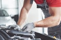 Picture showing muscular car service worker repairing vehicle Royalty Free Stock Photo