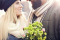 Picture showing young couple with flowers dating in the city Royalty Free Stock Photo