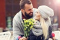 Picture showing young couple with flowers dating in the city Royalty Free Stock Photo