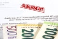 An application for short-time work allowance and euro banknotes