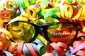 Glasses with the text it`s partytime and paper streamers Royalty Free Stock Photo