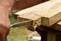 The working moment of the carpenter's work with a chisel with a board.