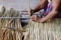 Picture shows how to make a panel vetiver for hut roof, handwork crafts of panel vetiver for hut roof, straw roof hut Royalty Free Stock Photo