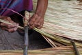 Picture shows how to make a panel vetiver for hut roof, handwork crafts of panel vetiver for hut roof, straw roof hut Royalty Free Stock Photo