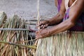 Picture shows how to make a panel vetiver for hut roof, handwork crafts of panel vetiver for hut roof, straw roof hut Royalty Free Stock Photo