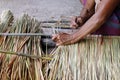 Picture shows how to make a panel vetiver for hut roof, handwork crafts of panel vetiver for hut roof, straw roof hut Royalty Free Stock Photo