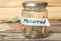 Mason jar, euro money and savings for motorcycle