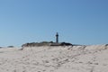 Cape May point lighthouse from the beach also showing part of the fort Royalty Free Stock Photo