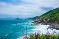 rocky coastline with turquoise-green water, green slopes and an absolutely blue sky Royalty Free Stock Photo