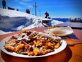 Sugared pancake with raisins in front of wintry scenery