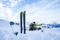 Picture of skis, ski poles against background of two sports women with thermos sitting in ski resort in winter. Royalty Free Stock Photo