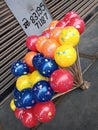 This is the picture of a small balloon being sold by a man.
