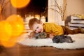 a picture of a small boy lying happily with two rabbits.