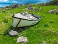 Small rowing boat on green grass Royalty Free Stock Photo