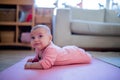 Smiling Baby Girl Lying Down on a Pink Rug Royalty Free Stock Photo