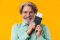 Smiling happy grey-haired man holding passport with tickets Royalty Free Stock Photo