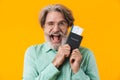 Smiling happy grey-haired man holding passport with tickets Royalty Free Stock Photo