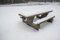 A picture of the snow-covered picnic table on the ground. Royalty Free Stock Photo