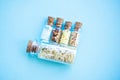 Picture with soft focus of five tiny glass jar with rice, buckwheat, millet, sugar and barley on blue background, top view. Royalty Free Stock Photo