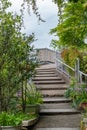 Picture of stairs in the park leading to the cloudy sky with rainy clouds Royalty Free Stock Photo