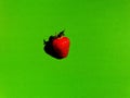 Strawberry with shadow on green background