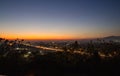 Sunset with busy highway and mountains in the distance