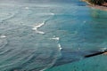 Surfers waiting for the right wave in azure waters