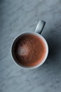 A picture taken above a coffee which stands on a white table.